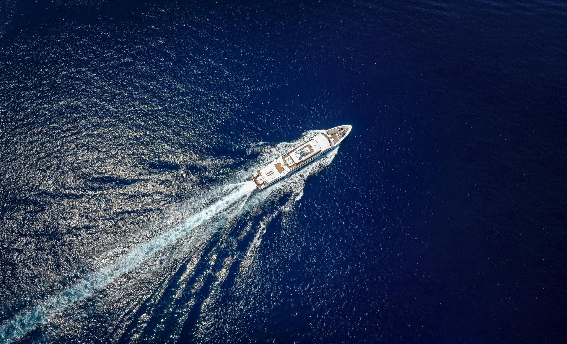 Aerial top view of a luxury yacht over the ocean