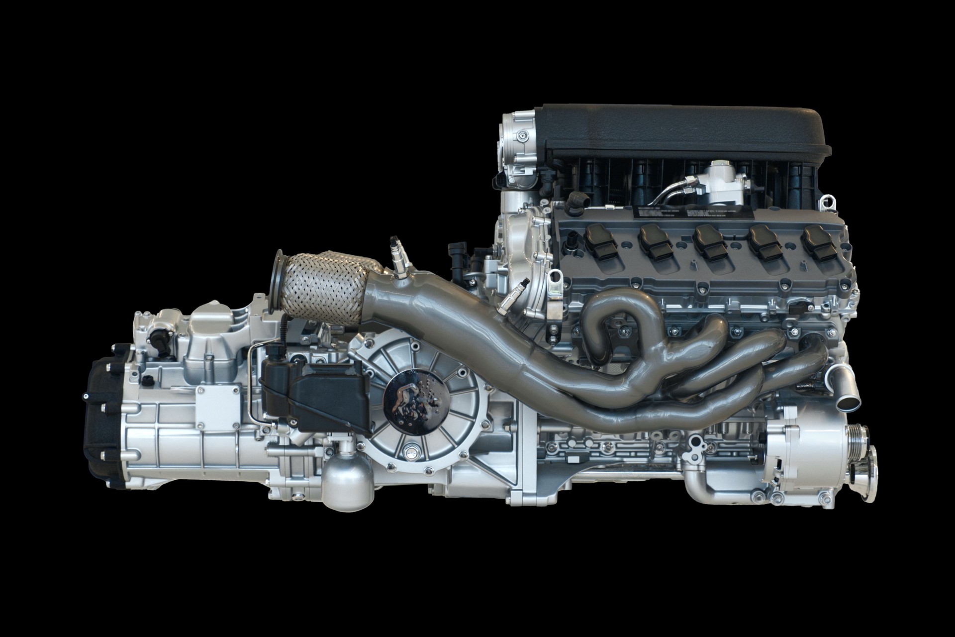 This high-performance V-type engine features a complex exhaust manifold, precision-machined components, and a compact layout, designed for maximum power output
