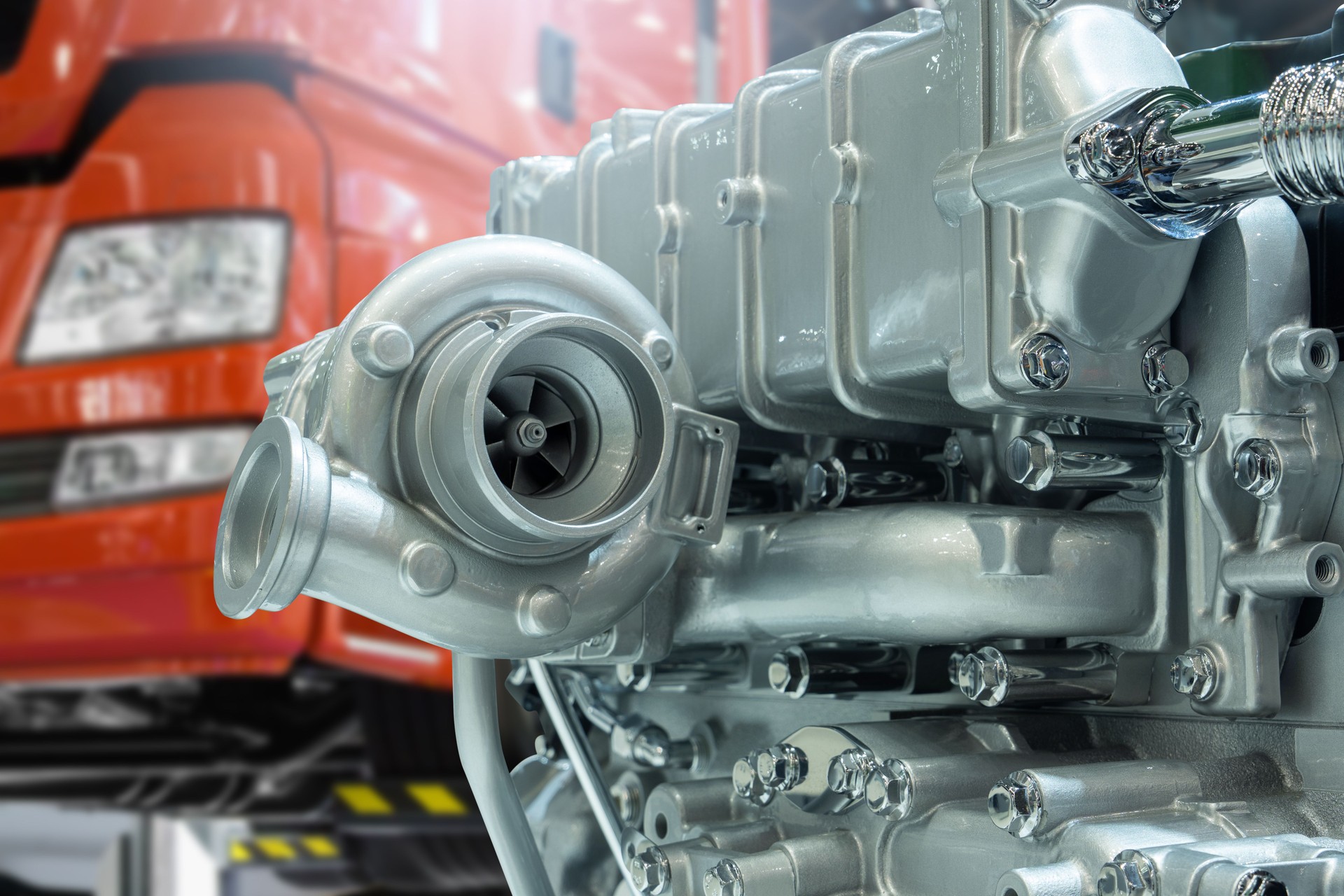 Close-up of diesel engine turbocharger on the background of truck repair service